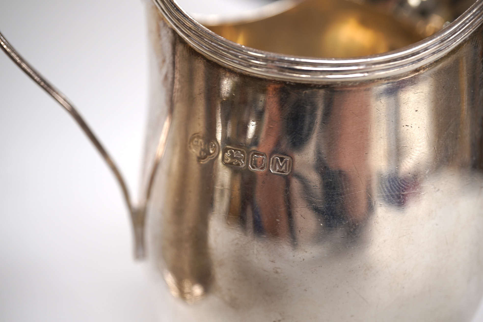 A Victorian engine turned silver christening mug by John Samuel Hunt (Hunt & Roskell), London, 1863, with later engraved inscription to the base, height 89mm, together with a George VI silver cream jug, London, 1947, 12o